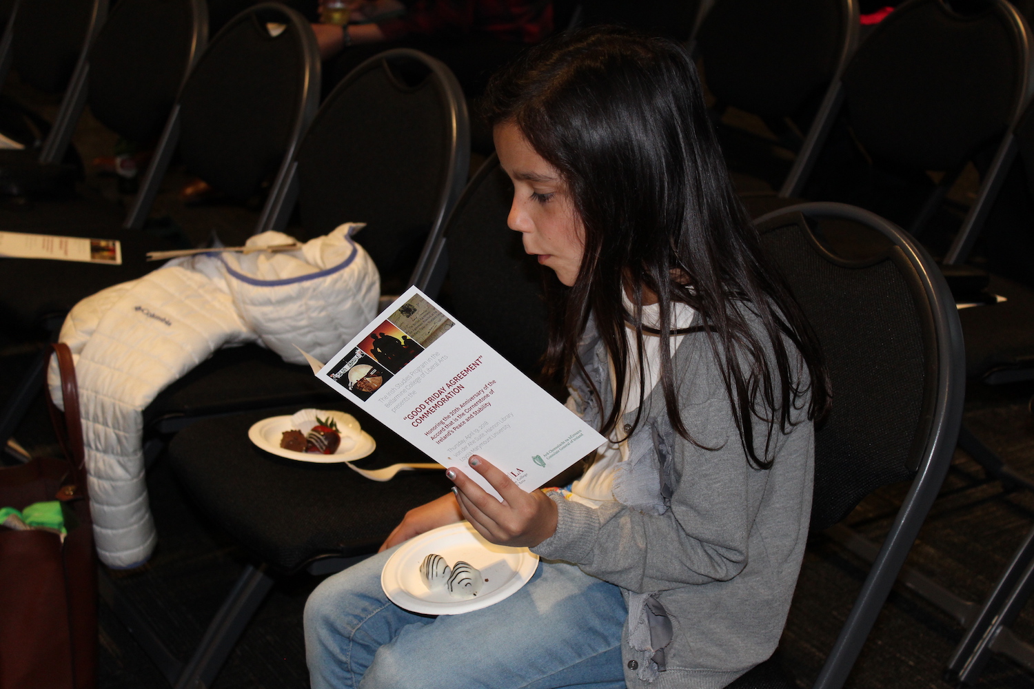 Little girl with program and treats during the reception of the 2018 Good Friday Agreement Commemoration